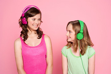 Image showing Two teenage friends enjoying music together