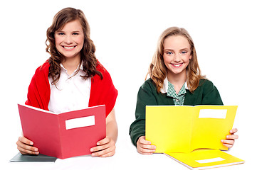 Image showing Smiling girl learning from school books