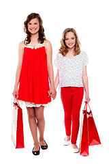 Image showing Glamorous girls walking after purchases