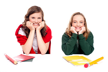 Image showing Happy young girls sitting at desk