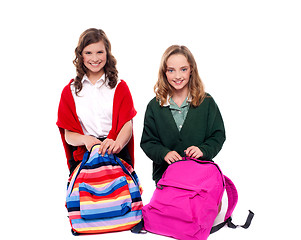 Image showing Pretty girls unzipping school bag