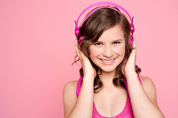 Image showing Pretty caucasian girl tuned into music