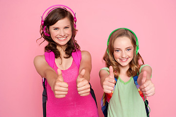 Image showing Two beautiful schoolgirls giving thumbs up