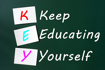Image showing KEY acronym -Keep educating yourself on a blackboard with sticky notes