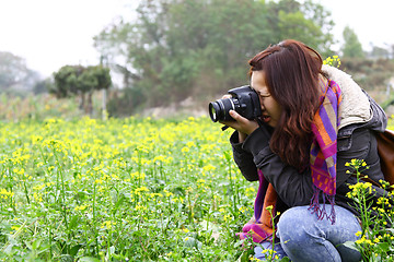 Image showing Female photographer on field