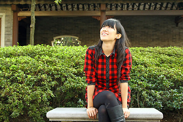 Image showing Chinese girl smiling in a garden