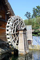 Image showing Water wheel next to a house