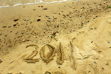 Image showing 2011 on sand