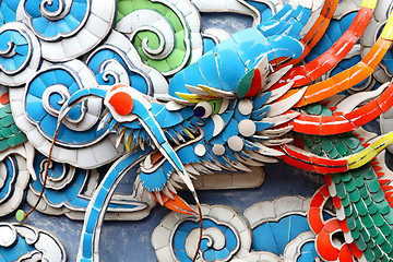 Image showing Colorful dragon carvings on wall