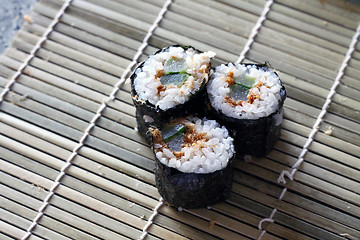 Image showing Home made sushi on bamboo plate