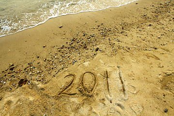 Image showing 2011 on sand