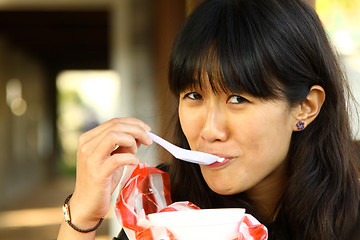 Image showing Asian woman eating dessert