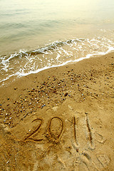 Image showing 2011 on sand