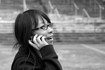 Image showing Asian woman using mobile phone and talking