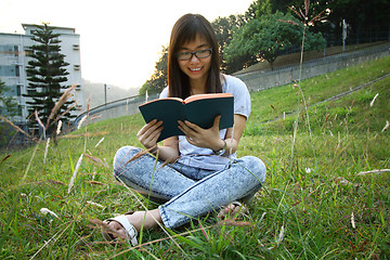 Image showing Asian girl reading in university