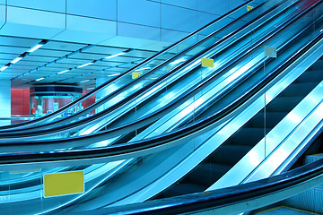 Image showing Moving escalator in modern interior, motion blurred.