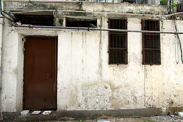 Image showing Old wall and door along a corridor