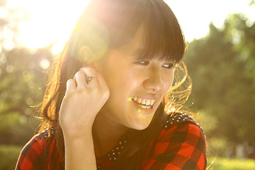 Image showing Asian woman smiling under sunshine