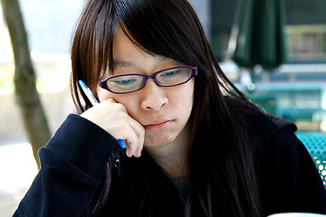 Image showing Asian girl thinking