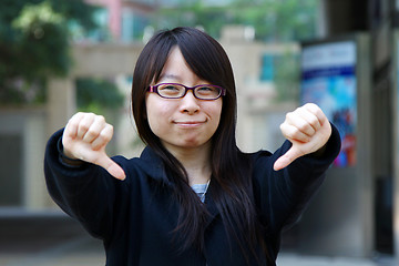 Image showing Asian woman thumbs down