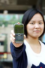 Image showing Asian woman shows her mobile phone