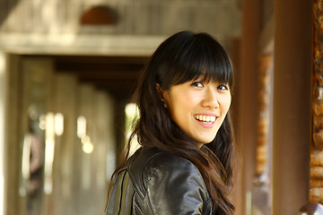 Image showing Asian woman in a garden smiling