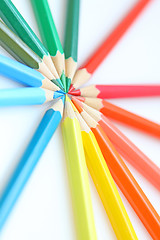 Image showing Color pencils in arrange in color wheel colors on white backgrou