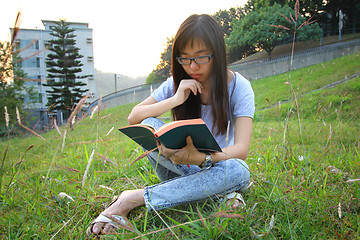 Image showing Asian girl reading in university