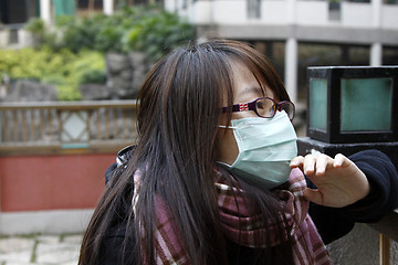 Image showing Asian sick girl wearing mask