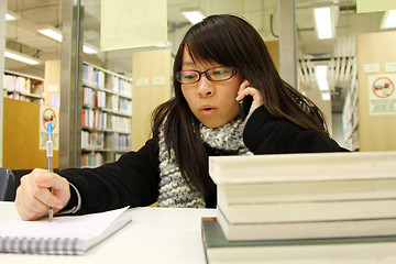 Image showing Asian woman using mobile phone and talking