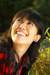 Image showing Asian woman smiling under sunshine