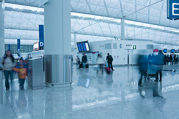 Image showing Moving people in airport in blue toned
