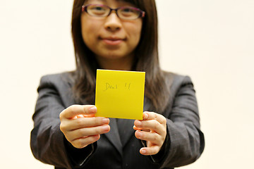 Image showing Businesswoman with deal memo paper on hands