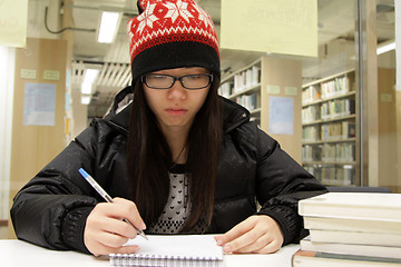 Image showing Asian woman studying in library