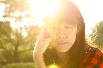 Image showing Asian woman thinking under sunshine