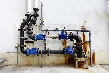 Image showing Rusted water pipes in a housing estate