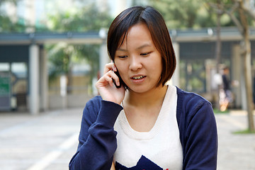 Image showing Asian woman using mobile phone and talking