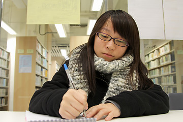 Image showing Asian woman studying hard in a university