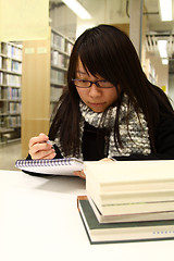 Image showing Asian woman studying hard in a university