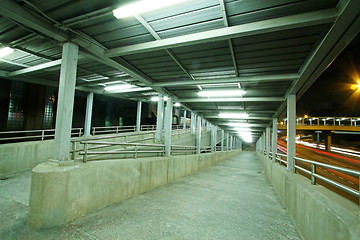 Image showing Footbridge at night with moving cars