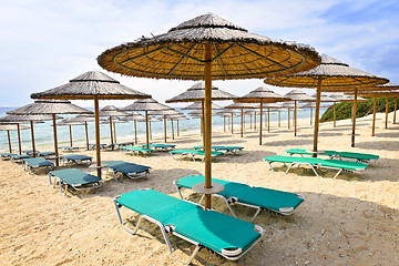 Image showing Beach umbrellas on sandy seashore