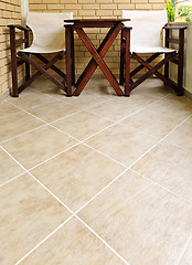 Image showing Chairs and table on tiled floor