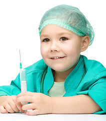 Image showing Cute little girl is playing doctor with syringe