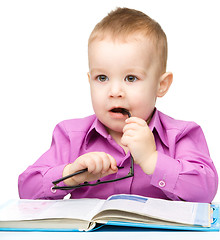 Image showing Cute little child play with book