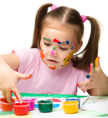 Image showing Cute cheerful child play with paints