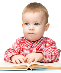 Image showing Cute little child play with book