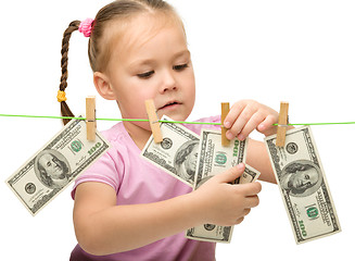 Image showing Cute little girl with paper money