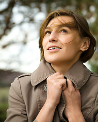 Image showing Portrait of a happy beautiful woman in autumn park