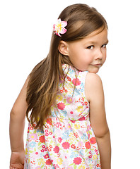 Image showing Little girl is looking back over her shoulder