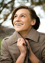 Image showing Portrait of a happy beautiful woman in autumn park